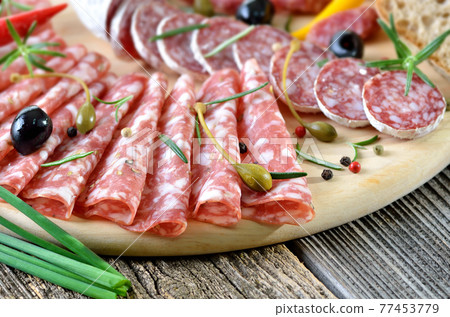 Snack with delicious French and Italian salami, spiced with rosemary and pepper Snack with delicious French and Italian salami, spiced with rosemary and pepper 77453779