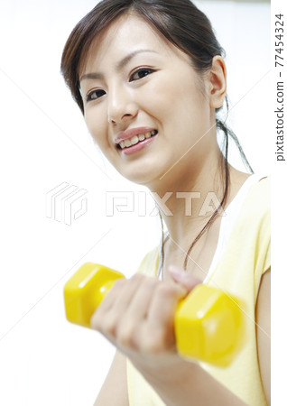 Women training on dumbbells Women training on dumbbells 77454324