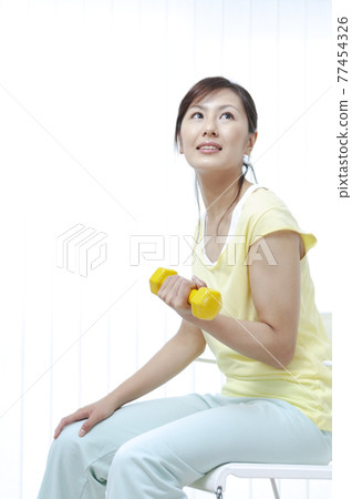 Women training on dumbbells Women training on dumbbells 77454326