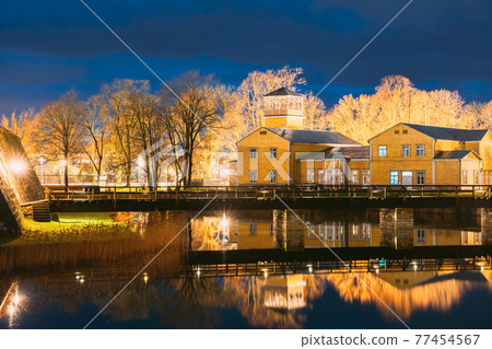 Kuressaare, Estonia. Old Traditional Yellow Wooden House In Evening Blue Hour Night 77454567