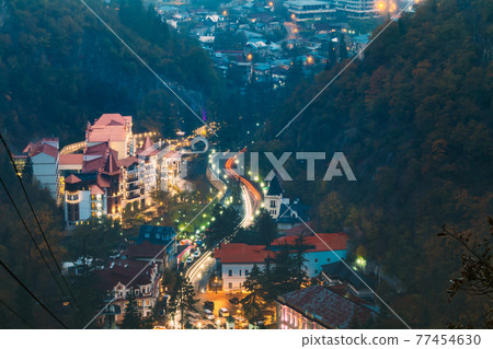 Borjomi, Samtskhe-Javakheti, Georgia. Aerial View Borjomi Cityscape, Hotel House And Central Park In Autumn October Evening Night In Night Illuminations Lights Lighting 77454630
