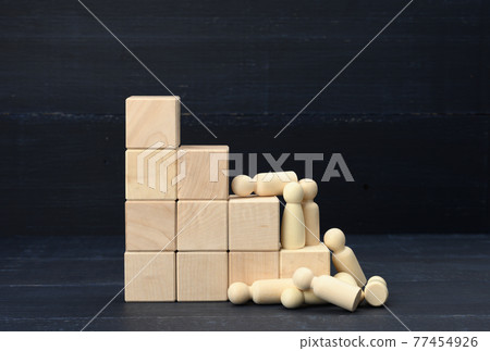 stairs from wooden cubes and a crowd of fallen wooden figures of men on a blue background stairs from wooden cubes and a crowd of fallen wooden figures of men on a blue background 77454926