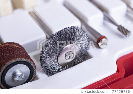 Sander attachments in white container close up Sander attachments in white container close up 77456786