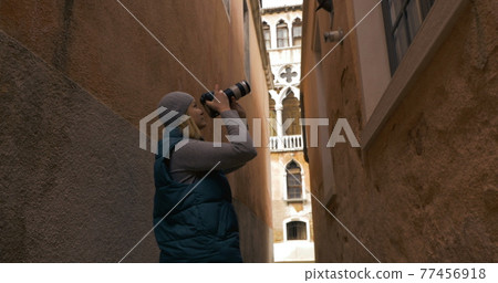 Woman trying to find a place for good shot Woman trying to find a place for good shot 77456918