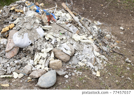 Pile of construction waste on the grass Pile of construction waste on the grass 77457037
