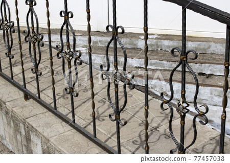 Black and yellow patterned wrought iron fence Black and yellow patterned wrought iron fence 77457038