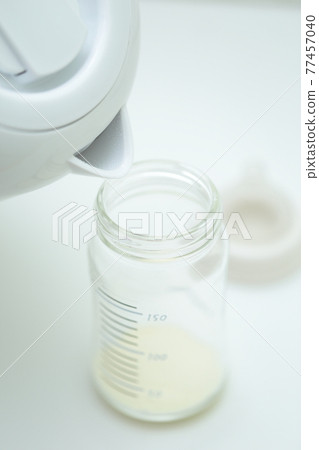Powdered milk in a baby bottle Powdered milk in a baby bottle 77457040