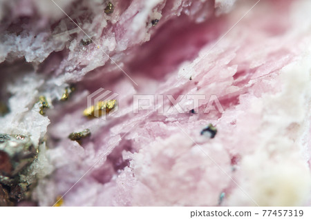 Pink crystals Rhodochrosite with particles of Pyrite. Natural texture of mineral for background. Beautiful background and wallpaper. Macro. Pink crystals Rhodochrosite with particles of Pyrite. Natural texture of mineral for background. Beautiful background and wallpaper. Macro. 77457319