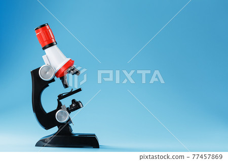 Microscope for laboratory medical research and experiments on a blue background. Microscope for laboratory medical research and experiments on a blue background. 77457869