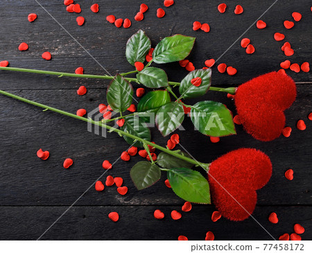 A red heart on a black background. 77458172