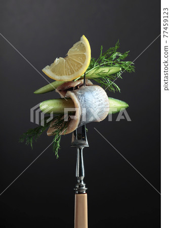 Herring fillet in oil with lemon, cucumber, and dill. Herring fillet in oil with lemon, cucumber, and dill. 77459123