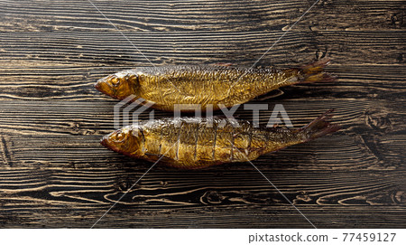 Smocked herring on an old wooden table. Smocked herring on an old wooden table. 77459127