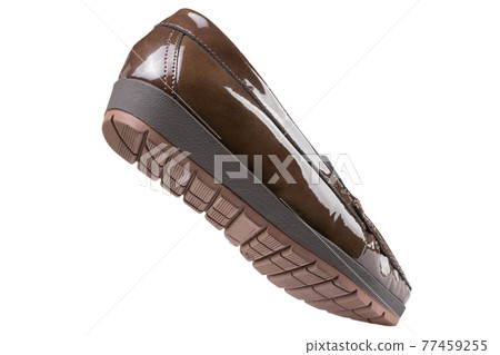 Brown women's patent leather low-soled shoes with a tread, as if walking, on a white background Brown women's patent leather low-soled shoes with a tread, as if walking, on a white background 77459255