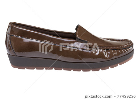 Brown women's patent leather low-soled shoes with a tread, on a white background Brown women's patent leather low-soled shoes with a tread, on a white background 77459256