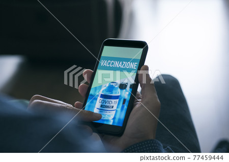 man and text vaccination in italian in smartphone man and text vaccination in italian in smartphone 77459444
