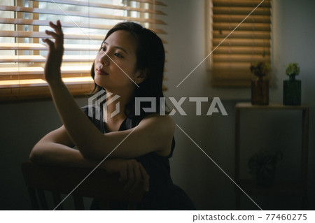 Woman staring at an engagement ring 1 77460275