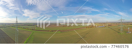 Aerial panoramic picture of a transformer station with many insulators and cables during the day Aerial panoramic picture of a transformer station with many insulators and cables during the day 77460576