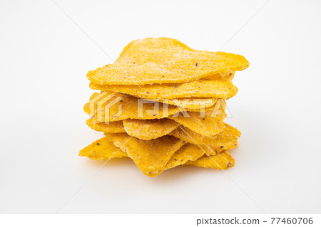 tower of Nachos on a white table. Mexican snack, corn tortilla chips. tower of Nachos on a white table. Mexican snack, corn tortilla chips. 77460706
