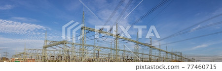 Picture of a transformer station with many insulators and cables during the day 77460715