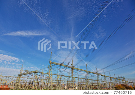 Picture of a transformer station with many insulators and cables during the day 77460716