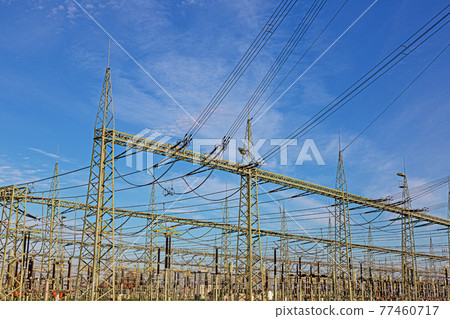 Picture of a transformer station with many insulators and cables during the day 77460717