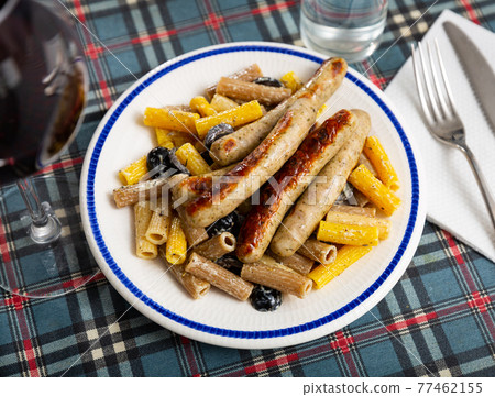 Creamy rigatoni pasta with olives and fried sausages Creamy rigatoni pasta with olives and fried sausages 77462155