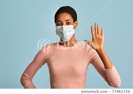 Black Woman In Protective Medical Mask On Face Waving Hand At Camera 77462159