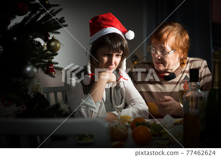 Quarrel of elderly mom and adult daughter on Christmas night Quarrel of elderly mom and adult daughter on Christmas night 77462624