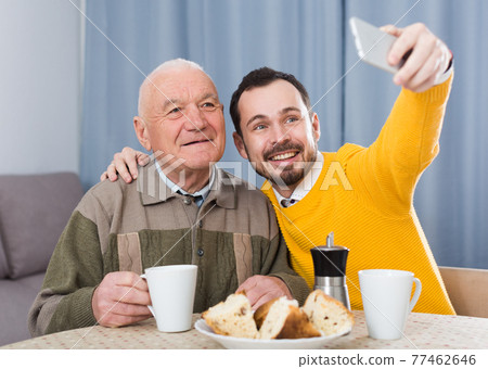 Elderly father and son doing selfie 77462646