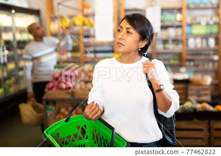 Portrait of woman with bag at store 77462822