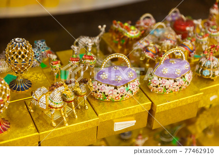 Colorful figurines decorated with crystals on showcase of Tbilisi gift shop 77462910