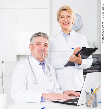 Doctor and nurse waiting for patients 77463067