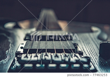 Closeup of wooden electric guitar with six strings 77463253