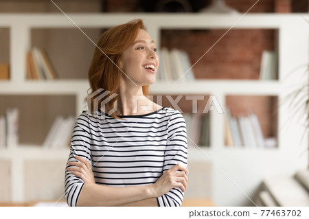 Head shot smiling dreamy motivated businesswoman looking to aside Head shot smiling dreamy motivated businesswoman looking to aside 77463702