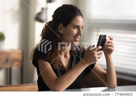 Latin female student make selfie on phone by classroom desk Latin female student make selfie on phone by classroom desk 77464005
