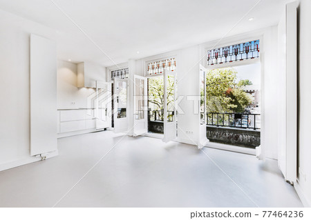 Spacious room with opened balcony doors Spacious room with opened balcony doors 77464236