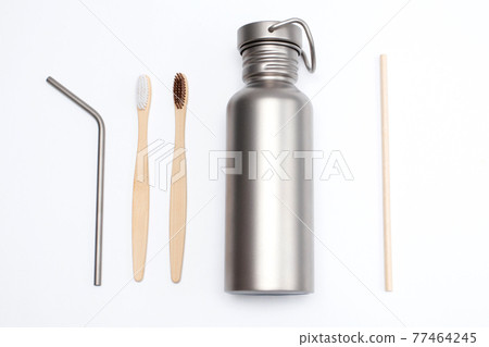 Bamboo toothbrushes with Titanium Hydration Bottle and reusable stainless steel straws. Zero waste concept Bamboo toothbrushes with Titanium Hydration Bottle and reusable stainless steel straws. Zero waste concept 77464245