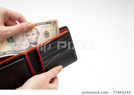 Paper currency in wallet with woman hands. Woman take dollar money out from wallet. Paper currency in wallet with woman hands. Woman take dollar money out from wallet. 77464248