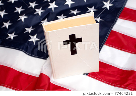 Holy Bible book with a cross on American flag Holy Bible book with a cross on American flag 77464251