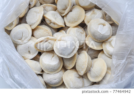 Frozen russian crude pelmen as a food background or texture Frozen russian crude pelmen as a food background or texture 77464942