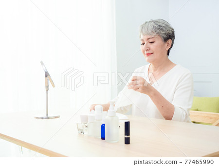 closeup senior asian woman's face and facial mask closeup senior asian woman's face and facial mask 77465990