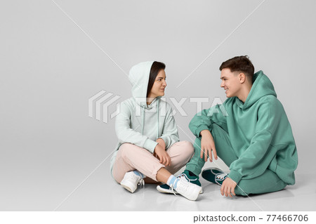 young couple wearing mint green casual hoodie 77466706