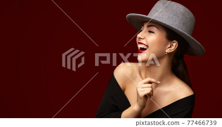 portrait of fashionable beautiful girl on red bakground. 77466739