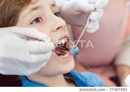 Boy during dental examination 77467493