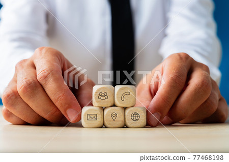 Wooden dices with contact icons of customer service 77468198