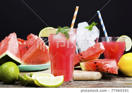 watermelon juice poured into a glass container watermelon juice poured into a glass container 77469391