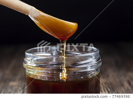 sweet honey flowing into jar sweet honey flowing into jar 77469398