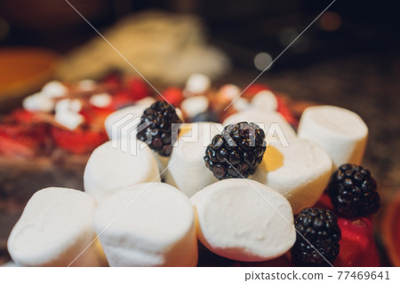 Decorated Biscuit Cake With Berries, Chocolate, Marshmallow On Grey Background. Close Up. Decorated Biscuit Cake With Berries, Chocolate, Marshmallow On Grey Background. Close Up. 77469641
