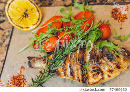 fried fish with fresh herbs and lemon. fried fish with fresh herbs and lemon. 77469680