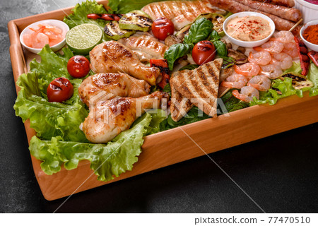 Composition of sausages, chicken, pork and shrimp prepared on grill, as well as vegetables prepared on grill with spices and herbs Composition of sausages, chicken, pork and shrimp prepared on grill, as well as vegetables prepared on grill with spices and herbs 77470510